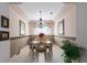 Dining room features neutral tones, decorative rope wall trim, and elegant chandelier at 6210 Laurel Creek Trl, Ellenton, FL 34222