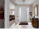 Bright foyer with tile flooring, a decorative console table, and views into the living area at 6210 Laurel Creek Trl, Ellenton, FL 34222