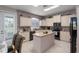 Bright eat-in kitchen with tiled floors, a center island, light cabinets and modern appliances at 6210 Laurel Creek Trl, Ellenton, FL 34222