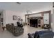 Living room with tile floors, a ceiling fan, a large TV and plenty of seating at 6210 Laurel Creek Trl, Ellenton, FL 34222