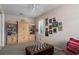 Living room with a leather sofa and ottoman with built-in shelving and a window at 6210 Laurel Creek Trl, Ellenton, FL 34222