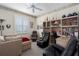 Home office boasting built-in shelves, comfortable seating, and natural light at 6210 Laurel Creek Trl, Ellenton, FL 34222