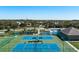 Overhead view of the community tennis courts and playground, surrounded by lush landscaping at 6210 Laurel Creek Trl, Ellenton, FL 34222