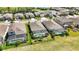 An aerial view displaying properties in a residential neighborhood, with a screened-in pool and lush landscaping at 6381 Mighty Eagle Way, Sarasota, FL 34241