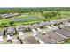 Expansive aerial perspective captures houses by lush golf course with pond at 6381 Mighty Eagle Way, Sarasota, FL 34241