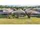 Aerial view of a home with a screened-in pool, manicured backyard, and landscaping at 6381 Mighty Eagle Way, Sarasota, FL 34241