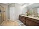 Bathroom with dual sinks, granite countertops, and a separate tiled shower at 6381 Mighty Eagle Way, Sarasota, FL 34241