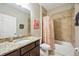 Bathroom featuring a vanity with granite countertop, tiled shower with tub, and decorative accents at 6381 Mighty Eagle Way, Sarasota, FL 34241