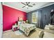 Bedroom features a colorful accent wall, comfortable bed, and a bright, airy window at 6381 Mighty Eagle Way, Sarasota, FL 34241