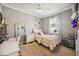 This bedroom has carpet floors, a window, and a white bed with pink linens at 6381 Mighty Eagle Way, Sarasota, FL 34241