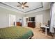 Spacious primary bedroom featuring a tray ceiling, a desk area, and a large window at 6381 Mighty Eagle Way, Sarasota, FL 34241