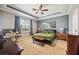 Bedroom with tray ceiling, desk, bedside tables, and accent wall art above the bed at 6381 Mighty Eagle Way, Sarasota, FL 34241