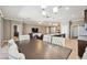 Open floor plan dining area flows into kitchen and living room, with modern lighting and neutral tones at 6381 Mighty Eagle Way, Sarasota, FL 34241