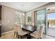 Dining room with dark wood table, upholstered chairs, and sliding glass doors to a screened lanai at 6381 Mighty Eagle Way, Sarasota, FL 34241