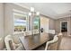 Dining room with dark wood table, upholstered chairs, and sliding glass doors to screened lanai at 6381 Mighty Eagle Way, Sarasota, FL 34241