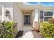 Inviting front entryway showcases brick accents, an updated light fixture, and manicured landscaping at 6381 Mighty Eagle Way, Sarasota, FL 34241