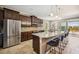 Modern kitchen featuring stainless steel appliances, a granite island with seating, and dark wood cabinetry at 6381 Mighty Eagle Way, Sarasota, FL 34241