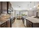 Modern kitchen with stainless steel appliances and view into the dining area and screened lanai at 6381 Mighty Eagle Way, Sarasota, FL 34241