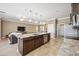 Open kitchen with large island and stainless appliances, flowing into living room at 6381 Mighty Eagle Way, Sarasota, FL 34241