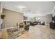 Open-concept living area with a stone fireplace, tile floors, and seamless flow to the kitchen at 6381 Mighty Eagle Way, Sarasota, FL 34241