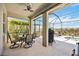 Covered patio area featuring comfortable outdoor seating and barbecue grill overlooking the backyard at 6381 Mighty Eagle Way, Sarasota, FL 34241