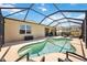 Backyard view of pool and patio with seating and the house's exterior at 6381 Mighty Eagle Way, Sarasota, FL 34241