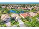 Beautiful aerial view of homes in a community surrounding a tranquil pond, with lush landscaping at 6458 Tailfeather Way, Bradenton, FL 34203