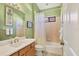 Bright bathroom features a single vanity, neutral tile, and shower-tub combo at 6458 Tailfeather Way, Bradenton, FL 34203