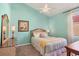 Comfortable bedroom featuring bright blue walls, soft bedding, and bedside lamps at 6458 Tailfeather Way, Bradenton, FL 34203