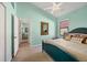 Comfortable bedroom featuring a blue bed frame, neutral bedding, and bright natural light at 6458 Tailfeather Way, Bradenton, FL 34203