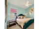 Cozy bedroom featuring a blue bed frame, neutral bedding, and a ceiling fan at 6458 Tailfeather Way, Bradenton, FL 34203
