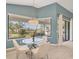Bright breakfast nook featuring a glass table, stylish chairs, and a large window with peaceful water view at 6458 Tailfeather Way, Bradenton, FL 34203