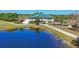 Stunning view of the clubhouse surrounded by a pond and lush green landscape at 6458 Tailfeather Way, Bradenton, FL 34203