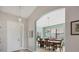 Dining room with natural light, complemented by stylish chandelier and archway at 6458 Tailfeather Way, Bradenton, FL 34203