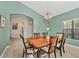 Elegant dining room features a chandelier, large windows and hardwood floors at 6458 Tailfeather Way, Bradenton, FL 34203