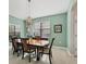 Traditional dining room boasts elegant chandelier, large windows, and light, bright walls at 6458 Tailfeather Way, Bradenton, FL 34203