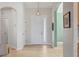 Welcoming entryway featuring light wood floors and a modern pendant light fixture at 6458 Tailfeather Way, Bradenton, FL 34203