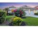 Charming single-story home with a well-manicured lawn, colorful flowers, and a two-car garage at 6458 Tailfeather Way, Bradenton, FL 34203