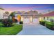 Charming single-story home with a well-manicured lawn, colorful flowers, and a two-car garage at 6458 Tailfeather Way, Bradenton, FL 34203