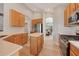 Spacious kitchen features an island, wooden cabinets and stainless steel appliances at 6458 Tailfeather Way, Bradenton, FL 34203