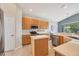 Well-lit kitchen features stainless appliances, center island, and quartz countertops at 6458 Tailfeather Way, Bradenton, FL 34203