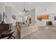 Open living area featuring high ceilings, neutral decor, and views into the kitchen area at 6458 Tailfeather Way, Bradenton, FL 34203