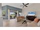 Bright living room boasts neutral tones and sliding doors that lead to a screened in lanai at 6458 Tailfeather Way, Bradenton, FL 34203