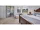 Bright bedroom featuring a seating area, ceiling fan, large windows and closet access at 6458 Tailfeather Way, Bradenton, FL 34203
