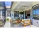 Inviting screened-in patio with outdoor seating and view into interior living space at 6458 Tailfeather Way, Bradenton, FL 34203