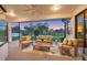 Inviting screened-in patio with comfortable seating, ceiling fan, and peaceful views of the lake at 6458 Tailfeather Way, Bradenton, FL 34203