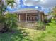 Inviting screened-in patio with comfortable outdoor seating overlooking the private backyard and manicured lawn at 686 Silk Oak Dr, Venice, FL 34293