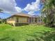 Landscaped backyard showcasing a screened-in patio and a fence at 686 Silk Oak Dr, Venice, FL 34293
