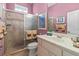 Bathroom featuring a shower with glass door, zebra-themed towels, and mauve-colored walls at 686 Silk Oak Dr, Venice, FL 34293