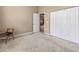 Bright bedroom with neutral walls, plush carpeting, and a spacious closet provides ample storage at 686 Silk Oak Dr, Venice, FL 34293